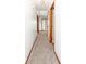 Bright hallway with white walls, tan carpeting, and several wood trim doorways at 9222 W State Road 38, Lapel, IN 46051