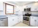 Modern kitchen with stainless steel appliances, ample white cabinetry, and natural light at 9222 W State Road 38, Lapel, IN 46051