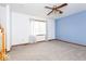 Spacious living room featuring a ceiling fan, large window, and blue accent wall at 9222 W State Road 38, Lapel, IN 46051