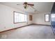 Spacious living room with large windows, ceiling fan and neutral carpeting at 9222 W State Road 38, Lapel, IN 46051