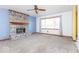 Inviting living room with a brick fireplace, large window and modern ceiling fan at 9222 W State Road 38, Lapel, IN 46051