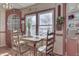 Charming kitchen featuring a wood table, built-in hutch, and sunny window at 1112 N Five Points Rd, Greenwood, IN 46143