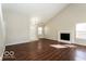 Bright living room with hardwood floors, high ceilings, and a fireplace at 13398 N Largo Ct, Camby, IN 46113