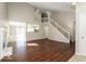 Spacious living room featuring hardwood floors, a fireplace, and a staircase to an upper level at 13398 N Largo Ct, Camby, IN 46113