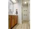 Clean bathroom with wood cabinets and updated flooring at 134 President W Trl, Indianapolis, IN 46229
