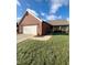 Brick ranch home with attached garage and landscaped yard at 134 President W Trl, Indianapolis, IN 46229