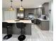 Modern kitchen with gray cabinets, stainless steel appliances, and an island at 134 President W Trl, Indianapolis, IN 46229