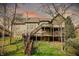 Expansive backyard featuring a multi-tiered deck and lush greenery at 14565 Geist Ridge Dr, Fishers, IN 46040