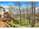 Multi-tiered deck and landscaping, offers an outdoor retreat, with lush greenery and mature trees at 14565 Geist Ridge Dr, Fishers, IN 46040