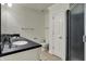 Bathroom with dual sinks, dark countertop, walk-in shower, and tiled flooring at 14565 Geist Ridge Dr, Fishers, IN 46040