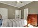 Inviting bedroom featuring a ceiling fan, hardwood floors, and a dresser for ample storage, creating a cozy retreat at 14565 Geist Ridge Dr, Fishers, IN 46040