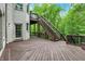 Beautiful home featuring a wooden deck, stairs, and a door leading outside from a brick wall at 14565 Geist Ridge Dr, Fishers, IN 46040