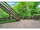 A spacious wood deck with stairs leading to a yard with lush greenery and a multi-level wooden patio at 14565 Geist Ridge Dr, Fishers, IN 46040