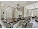 Open-concept dining room with modern lighting and view of the living and kitchen areas at 14565 Geist Ridge Dr, Fishers, IN 46040