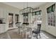 The dining room features natural light, stylish curtains, and a table with seating for six at 14565 Geist Ridge Dr, Fishers, IN 46040
