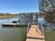 Wooden dock and steps by a lake with a metal structure behind it at 14565 Geist Ridge Dr, Fishers, IN 46040