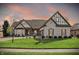 Beautiful, light brick home featuring a manicured lawn and Tudor-style architectural accents at 14565 Geist Ridge Dr, Fishers, IN 46040