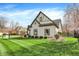 Well-manicured lawn and Tudor architectural accents highlight this home's side profile at 14565 Geist Ridge Dr, Fishers, IN 46040