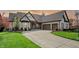 Attractive light brick home boasting a large driveway and well-maintained landscaping at 14565 Geist Ridge Dr, Fishers, IN 46040