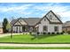 Charming light brick home with Tudor accents, lush lawn, and a welcoming curb appeal at 14565 Geist Ridge Dr, Fishers, IN 46040