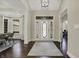 Bright foyer with decorative glass front door, hardwood floors, and adjacent dining room at 14565 Geist Ridge Dr, Fishers, IN 46040