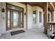 Inviting front porch showcasing brickwork and a decorative glass front door at 14565 Geist Ridge Dr, Fishers, IN 46040