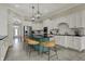 A well lit kitchen featuring a large island with bar seating, black countertops and white cabinets at 14565 Geist Ridge Dr, Fishers, IN 46040