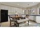 Bright eat-in kitchen with white cabinets and a view of the lush, wooded backyard at 14565 Geist Ridge Dr, Fishers, IN 46040