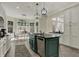 Kitchen with a dark island, stainless steel appliances, white cabinets and eat-in area at 14565 Geist Ridge Dr, Fishers, IN 46040
