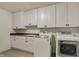 Laundry room boasts ample cabinetry, a sink, and modern washer and dryer appliances at 14565 Geist Ridge Dr, Fishers, IN 46040