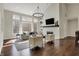 Bright living room featuring hardwood floors, a fireplace, and large windows offering ample natural light at 14565 Geist Ridge Dr, Fishers, IN 46040