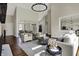 Inviting living room featuring hardwood floors, an open layout, and a view of the dining area and kitchen at 14565 Geist Ridge Dr, Fishers, IN 46040