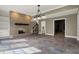 Living room showcasing a beautiful brick fireplace, stylish light fixture, and open floor plan at 14565 Geist Ridge Dr, Fishers, IN 46040