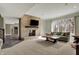 Living room featuring a brick fireplace, neutral walls and plush carpet at 14565 Geist Ridge Dr, Fishers, IN 46040