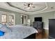Cozy main bedroom featuring a ceiling fan, large windows, and a TV on a dresser at 14565 Geist Ridge Dr, Fishers, IN 46040