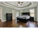 Main bedroom with hardwood floors, natural light, dresser, and a comfortable bed at 14565 Geist Ridge Dr, Fishers, IN 46040