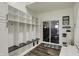 Mudroom featuring built-in storage, seating, and stylish wood-look flooring at 14565 Geist Ridge Dr, Fishers, IN 46040