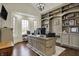 Spacious home office with custom built-in shelving, hardwood floors, and bay windows for ample natural light at 14565 Geist Ridge Dr, Fishers, IN 46040