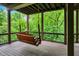Comfortable wood porch with a porch swing, offering a relaxing spot with a lush nature view at 14565 Geist Ridge Dr, Fishers, IN 46040
