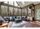 Sunroom featuring full view of the backyard through large windows with cozy wicker furniture at 14565 Geist Ridge Dr, Fishers, IN 46040