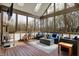 The sunroom has great light from large windows and a skylight, with cozy furniture and unique features at 14565 Geist Ridge Dr, Fishers, IN 46040