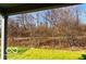 Backyard view from a covered patio, showcasing lush green grass and beautiful landscaping at 2212 Galleone Way, Plainfield, IN 46168