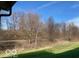 Peaceful backyard view overlooking a green lawn, trees, and natural surroundings at 2212 Galleone Way, Plainfield, IN 46168