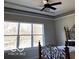 Bedroom with a decorative metal bed frame, tray ceiling, and a large window offering plenty of natural light at 2212 Galleone Way, Plainfield, IN 46168