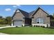 Brick house with gray garage door and landscaped lawn at 2212 Galleone Way, Plainfield, IN 46168