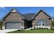 Brick home with gray accents, two-car garage, and manicured lawn at 2212 Galleone Way, Plainfield, IN 46168