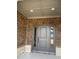 Charming gray front door with decorative glass sidelights and brick surround at 2212 Galleone Way, Plainfield, IN 46168