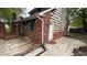 View of the backyard featuring a brick house with a wooden deck at 252 Ringwood Way, Anderson, IN 46013