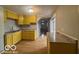 Kitchen with yellow cabinets, granite countertops, and hardwood floors at 252 Ringwood Way, Anderson, IN 46013