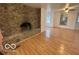 Living room with stone fireplace and hardwood floors at 252 Ringwood Way, Anderson, IN 46013
